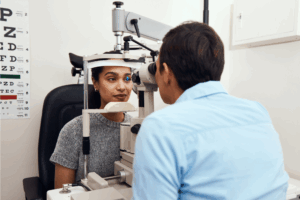 doctor performs an eye exam on patient